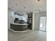 Modern kitchen featuring a spacious island, stainless steel appliances, and stylish pendant lighting at 3082 Se 140Th Ln, Summerfield, FL 34491