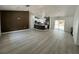 Open-concept living space with a modern kitchen, luxury vinyl flooring, and plenty of natural light at 3082 Se 140Th Ln, Summerfield, FL 34491
