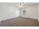 Bright carpeted bedroom with ceiling fan and a window offering natural light and closet for storage at 316 Georgetown Dr # 316, Casselberry, FL 32707