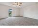 Spacious carpeted bedroom featuring a ceiling fan and sliding glass door to a balcony at 316 Georgetown Dr # 316, Casselberry, FL 32707