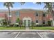 Charming two-story brick townhouse with lush landscaping and a well-maintained front yard and green doors at 316 Georgetown Dr # 316, Casselberry, FL 32707