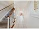 Bright hallway featuring tile flooring, a staircase, and white walls leading to the rest of the house at 316 Georgetown Dr # 316, Casselberry, FL 32707