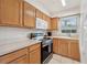 Functional kitchen with wood cabinetry, stainless steel appliances, and tile flooring at 316 Georgetown Dr # 316, Casselberry, FL 32707