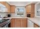 Cozy kitchen featuring oak cabinets, modern appliances, and ample counter space and window at 316 Georgetown Dr # 316, Casselberry, FL 32707