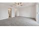 Large carpeted main bedroom featuring a ceiling fan, ensuite bath, and closet for storage at 316 Georgetown Dr # 316, Casselberry, FL 32707