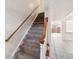 Carpeted staircase with wooden railing leading to the upper level of the home; tile flooring below at 316 Georgetown Dr # 316, Casselberry, FL 32707