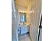 Cozy half bathroom features a vanity, mirror, and neutral tile flooring at 316 Georgetown Dr, Casselberry, FL 32707