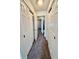 Well-lit hallway with multiple closets providing ample storage space and leading to other rooms at 316 Georgetown Dr, Casselberry, FL 32707