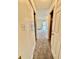 Hallway with closet space leading to the living area with neutral carpet and paint at 316 Georgetown Dr, Casselberry, FL 32707
