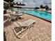 Community pool featuring lounge chairs, tables with umbrellas and clear, sparkling water at 316 Georgetown Dr, Casselberry, FL 32707
