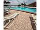 Community pool featuring lounge chairs, tables with umbrellas and clear, sparkling water at 316 Georgetown Dr, Casselberry, FL 32707