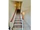 Carpeted staircase with wood railing leading to upper level, offering a bright and inviting entry at 316 Georgetown Dr, Casselberry, FL 32707
