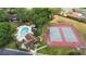 Aerial view of pool and tennis courts amenities with nearby housing at 4045 Crossroads Pl, Casselberry, FL 32707