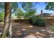 Backyard featuring a brick wall, mature trees, and plenty of space for outdoor enjoyment at 4045 Crossroads Pl, Casselberry, FL 32707
