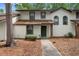 Charming two-story townhome featuring a welcoming front entrance and well-maintained landscaping at 4045 Crossroads Pl, Casselberry, FL 32707