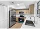 Bright kitchen featuring stainless steel appliances, light wood cabinets, and white countertops at 4045 Crossroads Pl, Casselberry, FL 32707