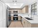 Bright kitchen featuring stainless steel appliances, light wood cabinets, and white countertops at 4045 Crossroads Pl, Casselberry, FL 32707