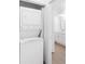 Convenient laundry area with stacked washer and dryer, located near the bathroom at 4045 Crossroads Pl, Casselberry, FL 32707