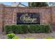 Elegant brick community signage reading 'The Village at Deer Run' surrounded by manicured greenery at 4045 Crossroads Pl, Casselberry, FL 32707