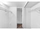 Walk-in closet with hanging racks and shelving and a door leading to a bathroom at 4045 Crossroads Pl, Casselberry, FL 32707