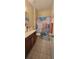 Bathroom featuring wood vanity with storage, tiled floor, and shower with colorful curtain at 4102 Feldspar Trl, Orlando, FL 32826