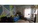 bedroom with cartoon themed artwork and furniture with natural light from the window at 4102 Feldspar Trl, Orlando, FL 32826