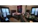 Bedroom featuring a dark wooden dresser, comfortable bedding, matching bedside lamps and decor at 4102 Feldspar Trl, Orlando, FL 32826