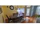 Inviting dining room with wood floors, table with seating, and natural light at 4102 Feldspar Trl, Orlando, FL 32826