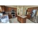 Open kitchen with stainless steel appliances, island and tiled floor at 4102 Feldspar Trl, Orlando, FL 32826