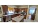 Bright kitchen with stainless appliances, tile backsplash, and center island at 4102 Feldspar Trl, Orlando, FL 32826