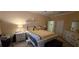 Comfortable main bedroom with decorative touches, including a decorative bedframe, bright yellow bedding and ensuite bathroom at 4102 Feldspar Trl, Orlando, FL 32826