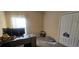 Comfortable office featuring a modern desk, computer setup, and closet providing plenty of storage space at 4102 Feldspar Trl, Orlando, FL 32826