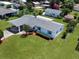 Aerial view of home featuring well-manicured lawn, covered parking and blue shutters at 413 5Th S St, Dundee, FL 33838
