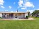 Exterior view of a spacious, screen enclosed patio with exterior lawn at 413 5Th S St, Dundee, FL 33838