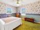 Bedroom with floral wallpaper, ceiling fan, and ample storage space at 413 5Th S St, Dundee, FL 33838