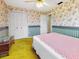 Bedroom featuring floral wallpaper, ceiling fan, and closet space at 413 5Th S St, Dundee, FL 33838