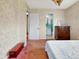 Bedroom featuring neutral walls, access to the bathroom and lots of natural light at 413 5Th S St, Dundee, FL 33838