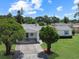 Charming single-story home with a covered entryway, well-maintained lawn, and mature trees at 413 5Th S St, Dundee, FL 33838