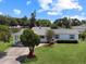 Well-kept single-story home featuring a lovely lawn and a convenient carport for parking at 413 5Th S St, Dundee, FL 33838