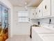 Laundry room with painted door art, washer, dryer, and overhead storage at 413 5Th S St, Dundee, FL 33838