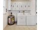 Laundry room featuring washer, dryer, and hot water heater at 413 5Th S St, Dundee, FL 33838