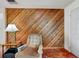Comfortable living room featuring wood paneling, and a cozy armchair at 413 5Th S St, Dundee, FL 33838