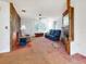 Bright living room featuring a fireplace, wood paneling, and comfortable seating at 413 5Th S St, Dundee, FL 33838