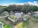 Stunning aerial view of a well-maintained home with palm trees and lush landscaping at 502 Canopy Ln, Lady Lake, FL 32159