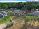 An aerial view showcases a home with green lawn, mature trees, and manicured hedges at 502 Canopy Ln, Lady Lake, FL 32159
