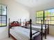 Bedroom featuring twin beds, a ceiling fan and a large window at 502 Canopy Ln, Lady Lake, FL 32159