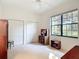 Bright bedroom featuring two closets, a ceiling fan and a large window at 502 Canopy Ln, Lady Lake, FL 32159