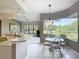 Eat-in kitchen nook with panoramic windows offering serene views of the landscaped exterior at 502 Canopy Ln, Lady Lake, FL 32159