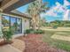 Attractive home exterior featuring a well-maintained yard, mature trees, and tropical landscaping at 502 Canopy Ln, Lady Lake, FL 32159