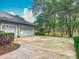Three car garage and large driveway complemented by mature shade trees at 502 Canopy Ln, Lady Lake, FL 32159